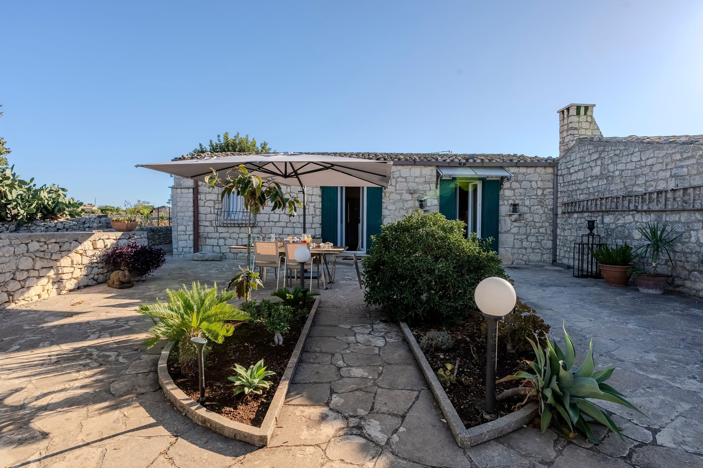 Sunlit courtyard with stone terrace